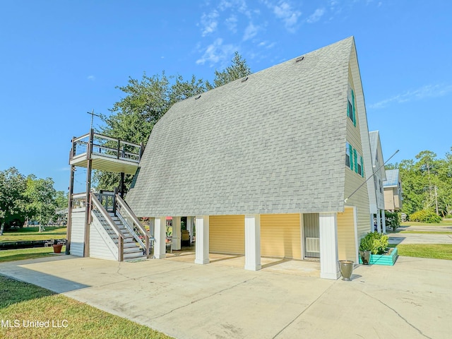 view of home's community featuring stairs and driveway