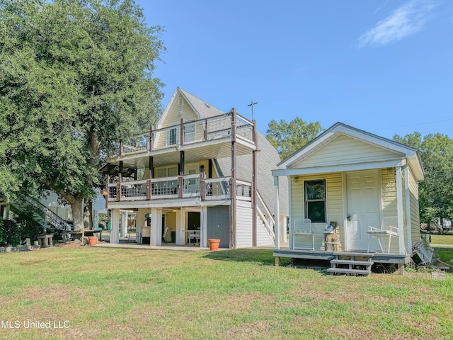 view of front of house with a balcony, a front yard, and covered porch