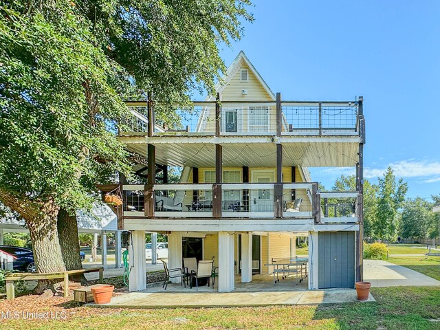 6085 Apache Dr, Kiln, MS 39556 - rear view of property with a patio area, a yard, and a balcony