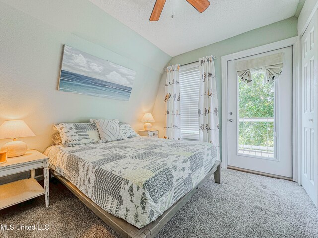 6085 Apache Dr, Kiln, MS 39556 - carpeted bedroom featuring access to outside, a ceiling fan, vaulted ceiling, and multiple windows