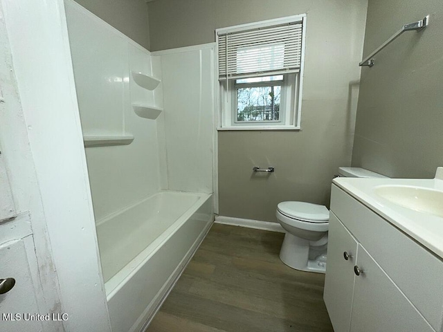 full bath featuring vanity, wood finished floors, toilet, and baseboards