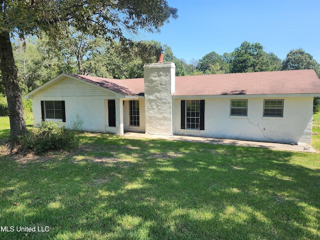 rear view of house with a yard