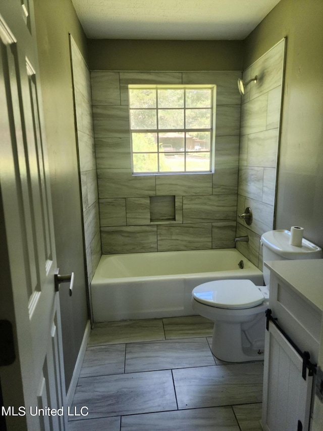 full bathroom with vanity, toilet, and tiled shower / bath