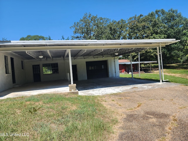 garage with a lawn and a carport