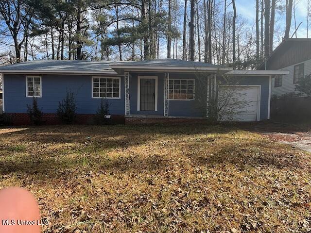 single story home featuring an attached garage, a porch, and a front yard