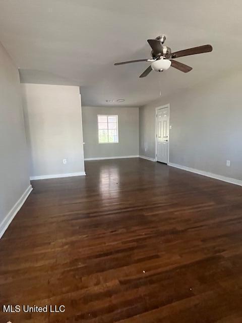 unfurnished room featuring dark hardwood / wood-style floors and ceiling fan