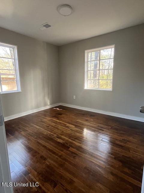 spare room featuring dark hardwood / wood-style flooring