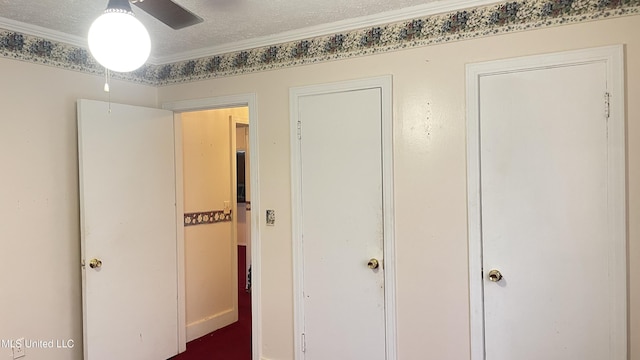 hall featuring crown molding and a textured ceiling