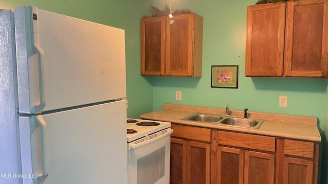 kitchen featuring white appliances and sink