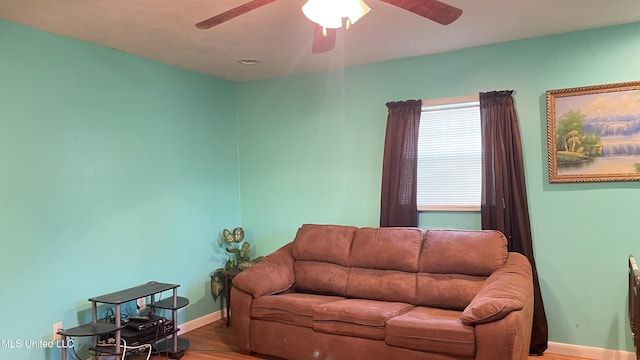 living room featuring hardwood / wood-style flooring and ceiling fan