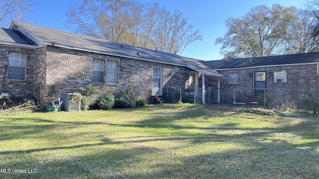 rear view of house with a yard