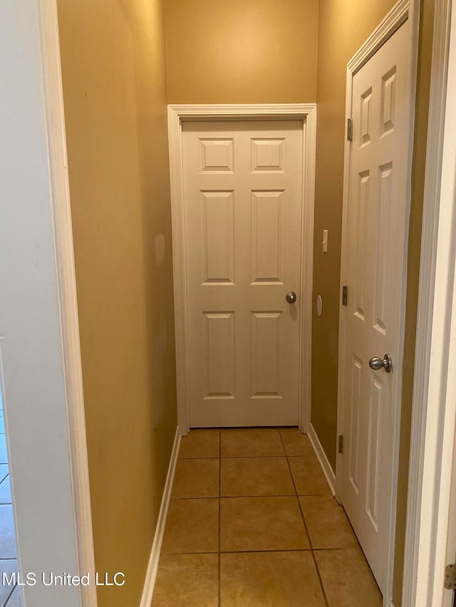 hall featuring light tile patterned flooring