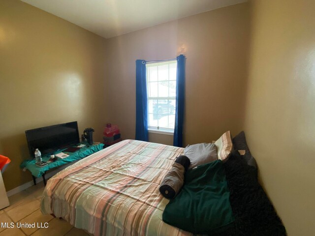 bedroom with light tile patterned flooring