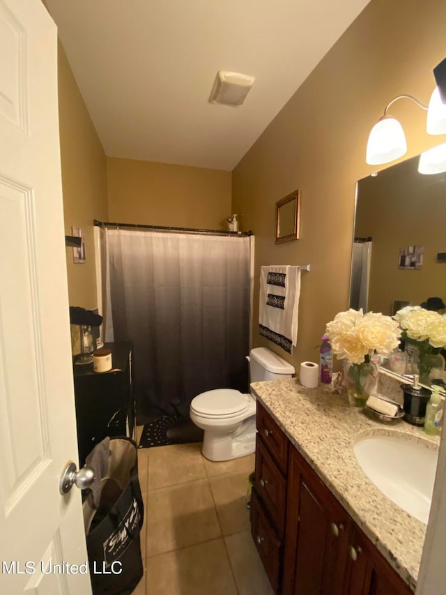 bathroom featuring vanity, toilet, tile patterned floors, and a shower with curtain