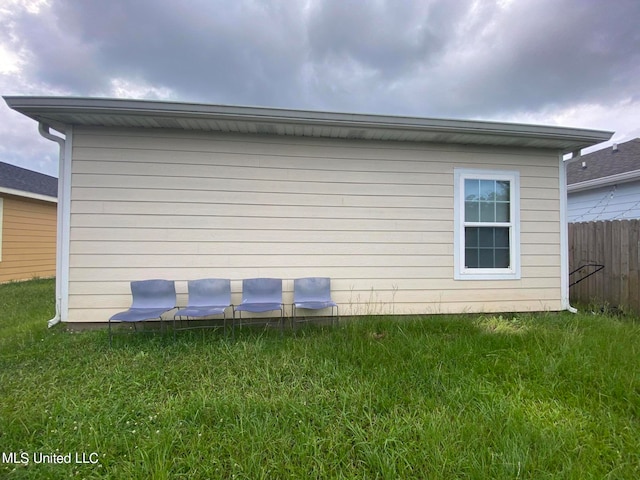 view of side of home with a yard