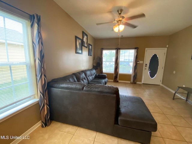 living room with light tile patterned flooring, ceiling fan, and plenty of natural light