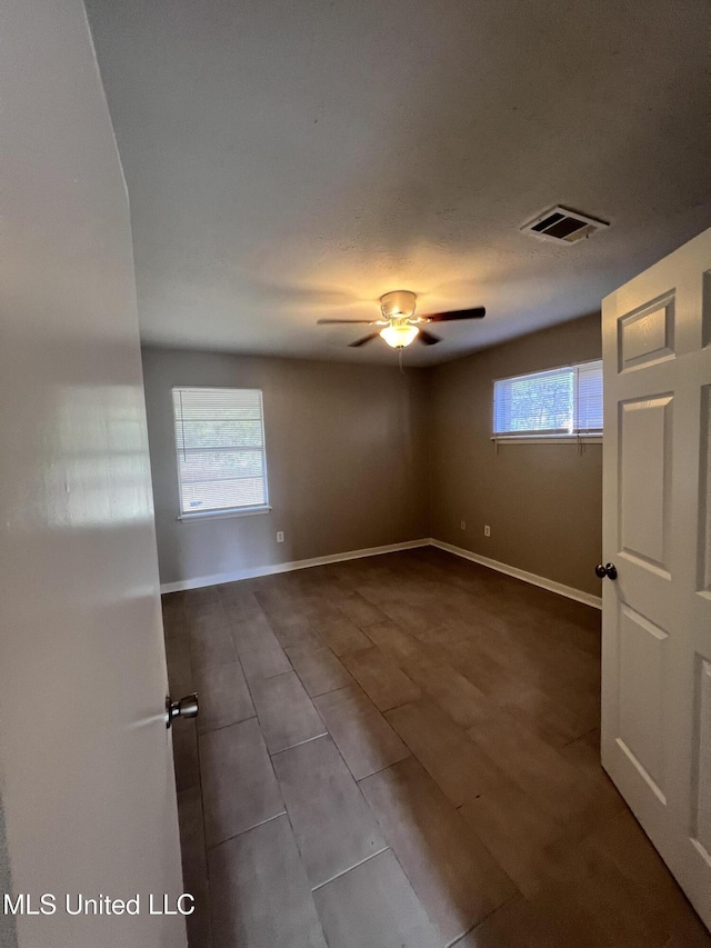 4224 Cypress Dr, Jackson, MS 39212 - empty room featuring ceiling fan, baseboards, and dark tile patterned flooring