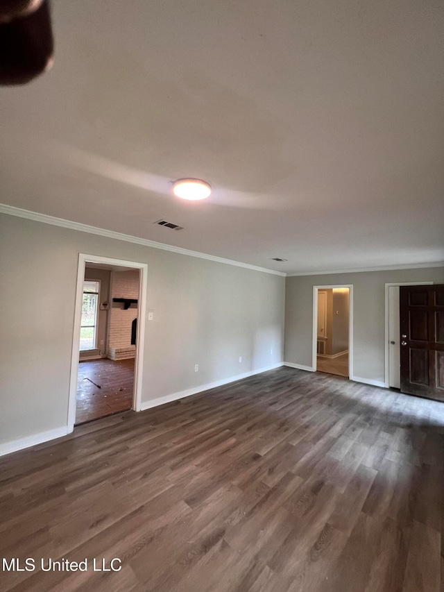 unfurnished room with ornamental molding and dark hardwood / wood-style floors