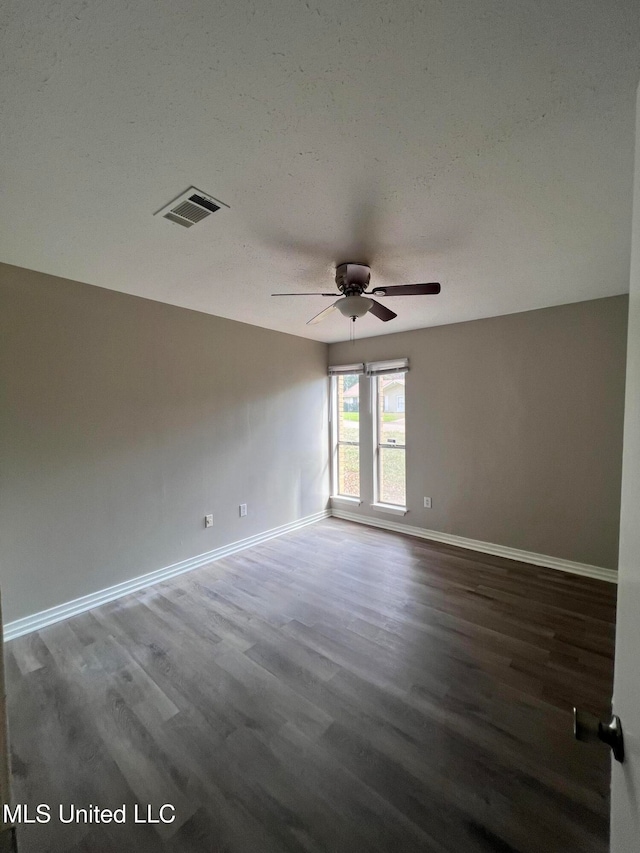 empty room with ceiling fan and wood-type flooring