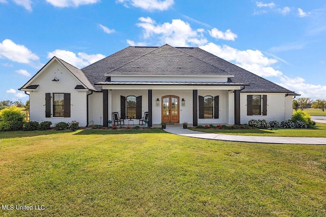 view of front of house with a front yard and a porch