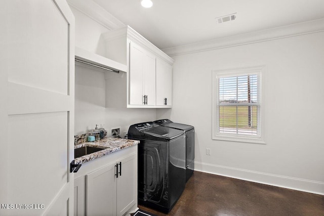 washroom with ornamental molding, cabinets, and separate washer and dryer