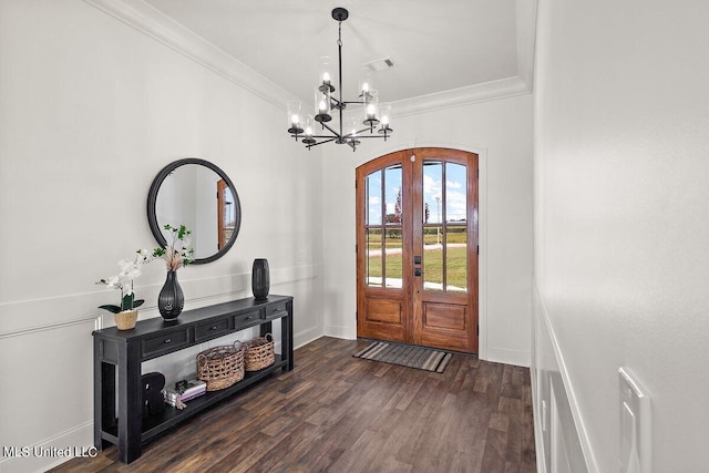 entryway featuring french doors, crown molding, a notable chandelier, and dark hardwood / wood-style floors