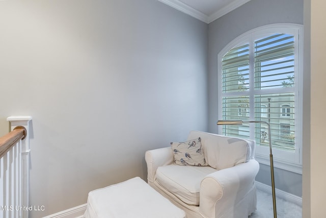 living area with crown molding and carpet floors