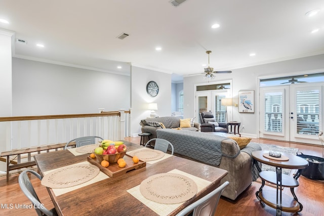 dining room with french doors, crown molding, wood-type flooring, and ceiling fan