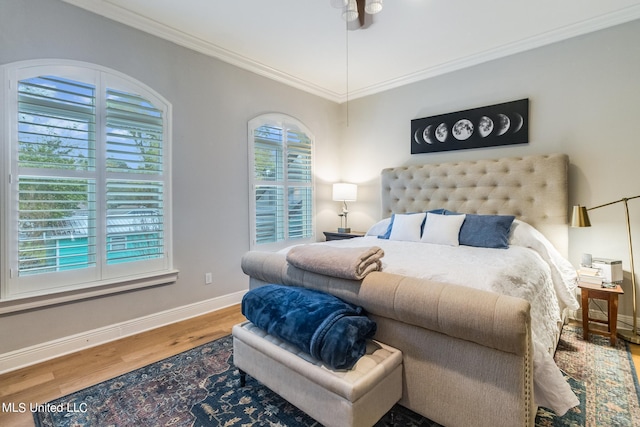 bedroom with ornamental molding and hardwood / wood-style floors