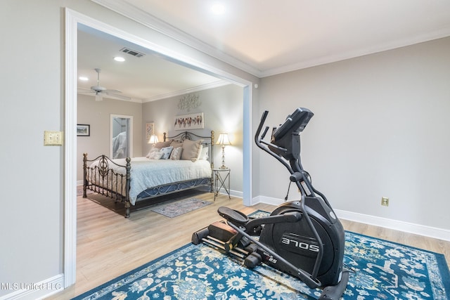 bedroom with ornamental molding, wood-type flooring, and ceiling fan