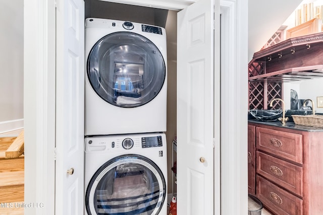 laundry area featuring stacked washer and dryer