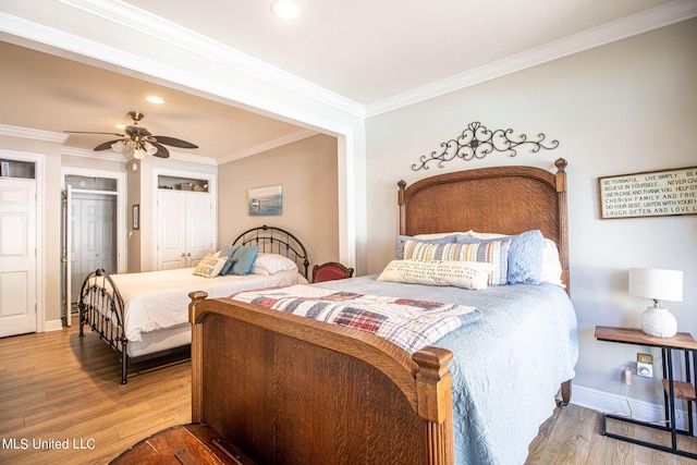 bedroom with crown molding, wood-type flooring, and ceiling fan