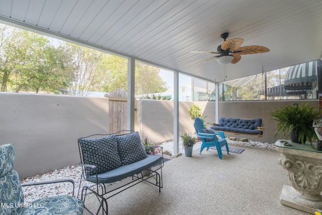 sunroom / solarium featuring ceiling fan