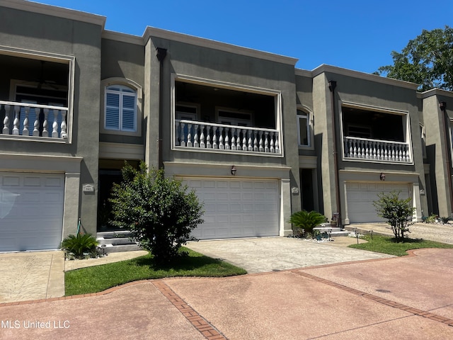 view of front of house with a garage and a balcony