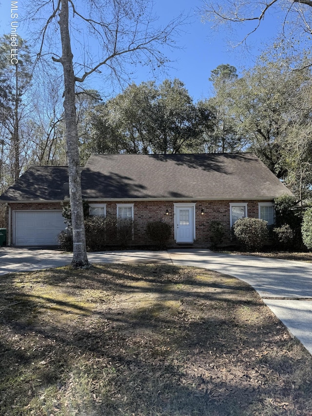 ranch-style house featuring a shingled roof, concrete driveway, brick siding, and an attached garage