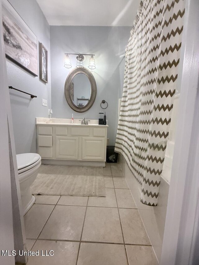 full bath with vanity, tile patterned flooring, and toilet