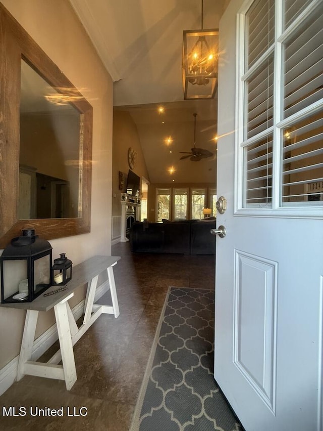 interior space with high vaulted ceiling and baseboards