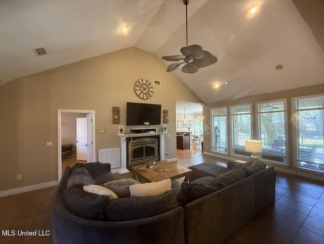 living area featuring high vaulted ceiling, ceiling fan, a fireplace, and visible vents