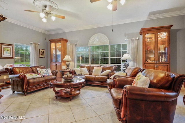 living area with ornamental molding, light tile patterned floors, and ceiling fan