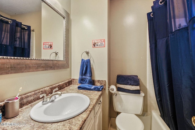 full bathroom featuring toilet, shower / tub combo with curtain, and vanity