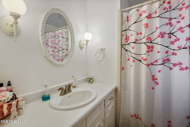 bathroom featuring vanity and a shower with shower curtain