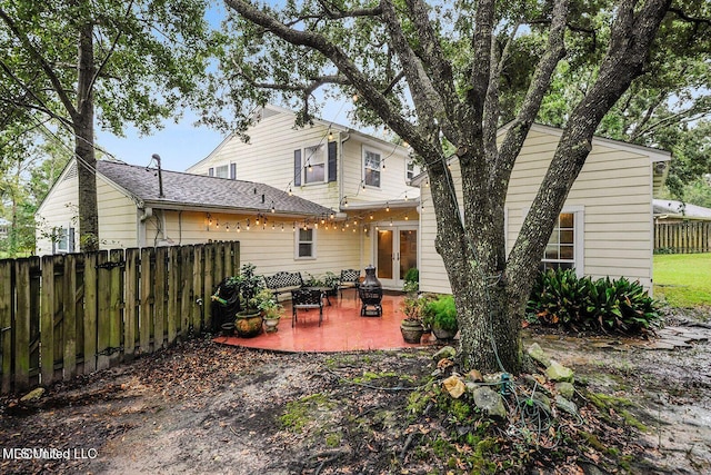 back of house featuring a patio, fence, and french doors