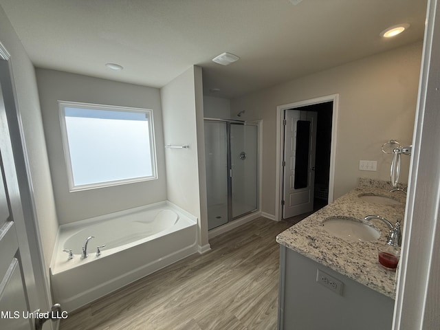 bathroom featuring hardwood / wood-style floors, vanity, and independent shower and bath