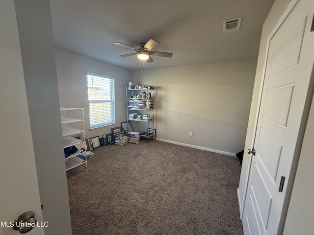 miscellaneous room with dark colored carpet and ceiling fan