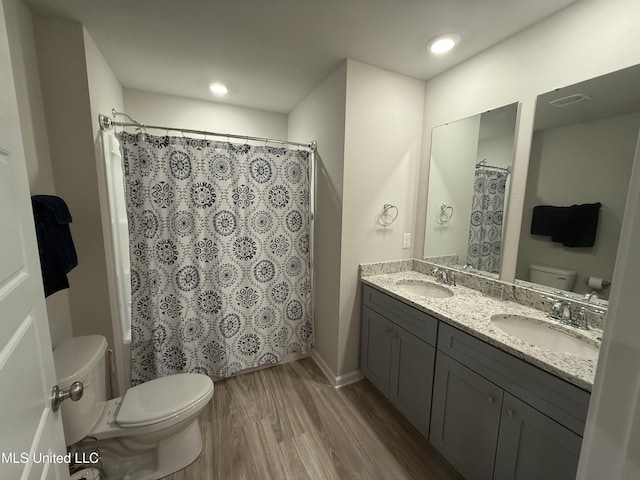 bathroom featuring hardwood / wood-style floors, vanity, toilet, and a shower with curtain