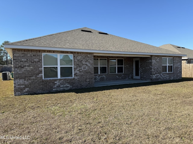 back of house featuring a lawn, central AC, and a patio