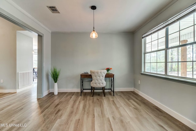 interior space featuring crown molding and light hardwood / wood-style floors