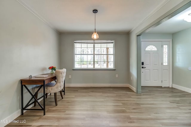 entryway featuring ornamental molding and light wood-type flooring