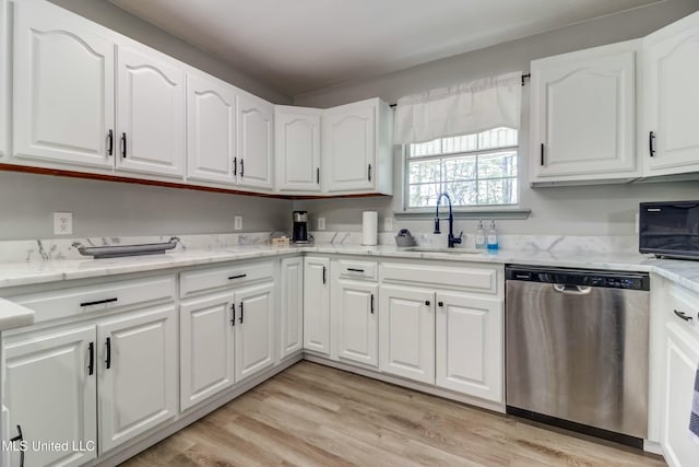 kitchen with white cabinets, sink, light stone counters, stainless steel dishwasher, and light hardwood / wood-style flooring