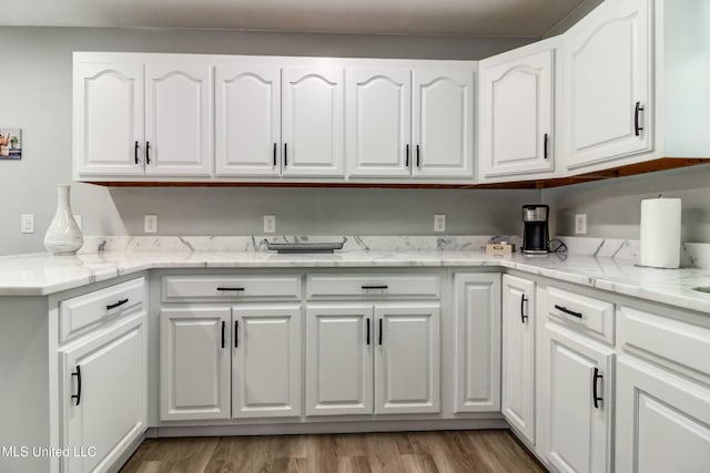 clothes washing area with light wood-type flooring